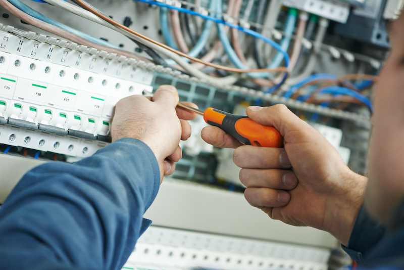 Image of electrician working in distribution board